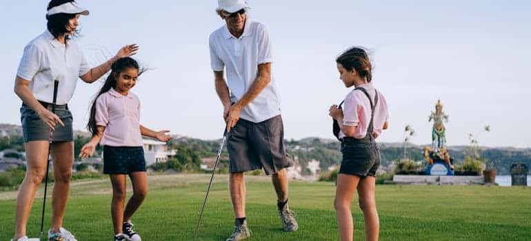 A family playing golf and enjoying family-friendly fun in Boca Raton