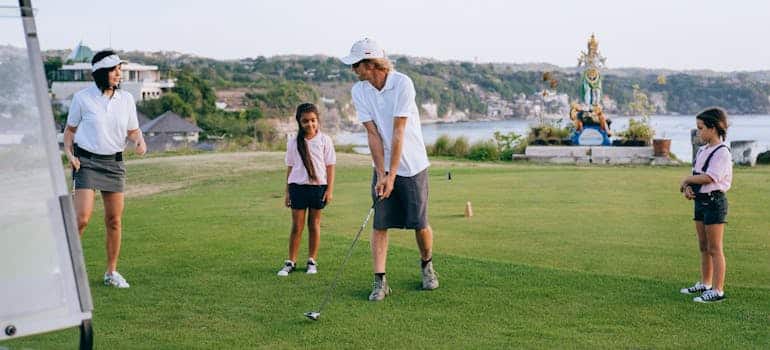 A family playing golf in one of the country clubs in Boca Raton