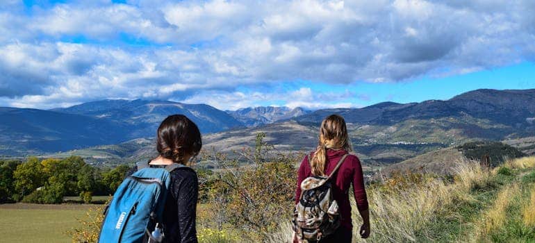 Two women hiking and talking about the reasons people decide to leave Miami