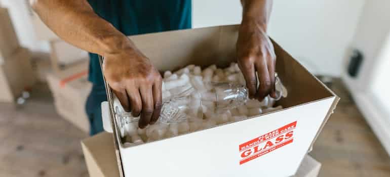A person packing glasses