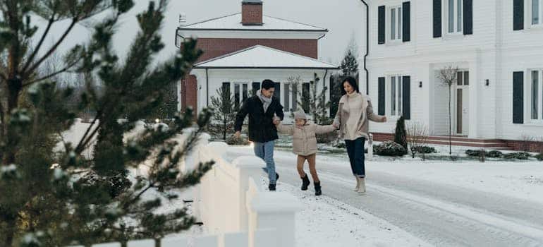 A family on the street representing Floridians moving to cold climates