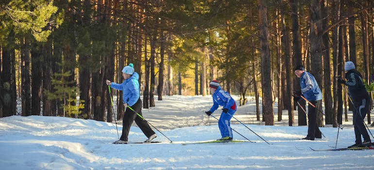 Four people skiing representing Floridians moving to cold climates