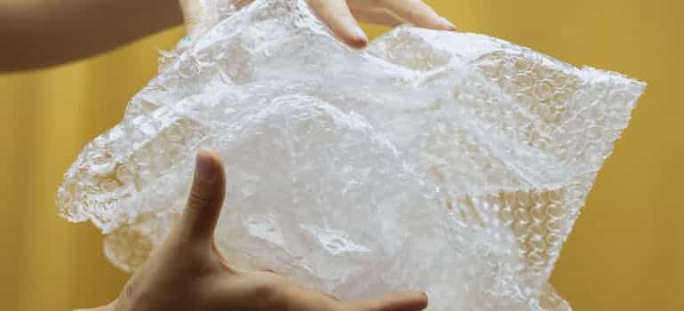 A person holding a bubble wrap